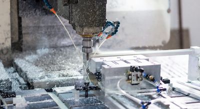 CNC machine cutting a piece of metal